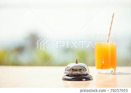 The desk cafe, restaurant bell and fresh juice for warn that the beverage is ready. Roof of beach cafe with sea and palm tree view The desk cafe, restaurant bell and fresh juice for warn that the beverage is ready. Roof of beach cafe with sea and palm tree view 79257055