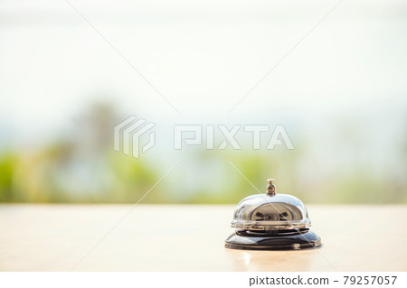 .The desk cafe, restaurant with a service bell for warn that the dish is ready. Roof of beach cafe with sea and palm tree view .The desk cafe, restaurant with a service bell for warn that the dish is ready. Roof of beach cafe with sea and palm tree view 79257057