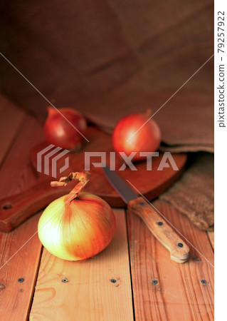 Onion and slices on wooden cutting board. onions at the wooden table Onion and slices on wooden cutting board. onions at the wooden table 79257922