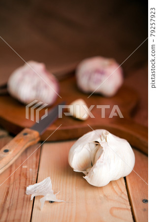 Garlic cloves and garlic bulb on a white wooden table 79257923