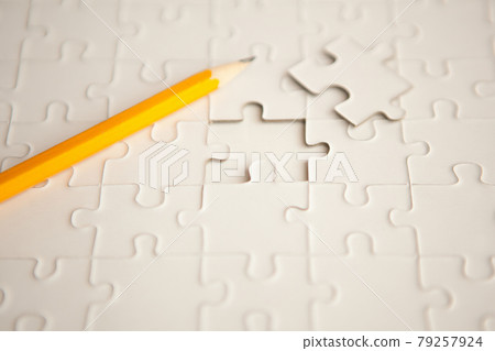 yellow pencil, puzzle with missing piece - solution concept. plan white puzzle surface texture with copy space. yellow pencil, puzzle with missing piece - solution concept. plan white puzzle surface texture with copy space. 79257924