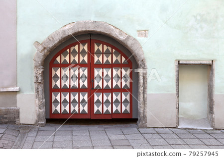 Colorful antique gates or doors. Wooden door with decoration elements in old building facade. Tallinn, Estonia Colorful antique gates or doors. Wooden door with decoration elements in old building facade. Tallinn, Estonia 79257945