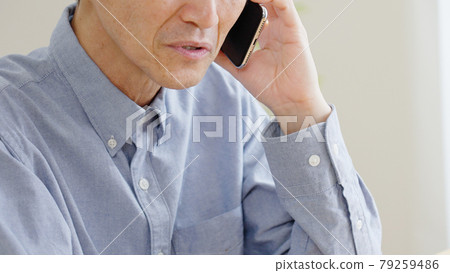 Senior man calling on a smartphone Senior man calling on a smartphone 79259486