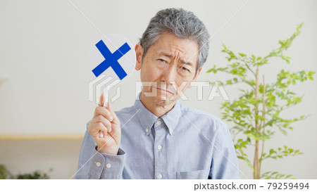 Senior man with a cross mark tag Senior man with a cross mark tag 79259494