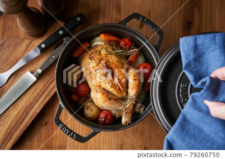 Roast chicken baked in a casting pan 79260750