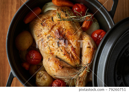 Roast chicken baked in a casting pan 79260751