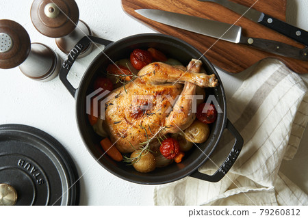 Roast chicken baked in a casting pan Roast chicken baked in a casting pan 79260812