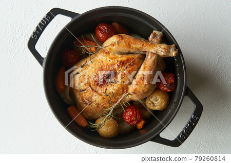Roast chicken baked in a casting pan 79260814