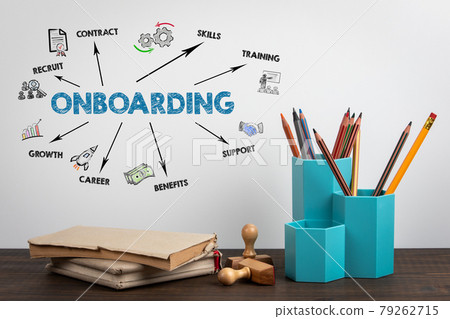 ONBOARDING. Office supplies and books on a wooden table ONBOARDING. Office supplies and books on a wooden table 79262715