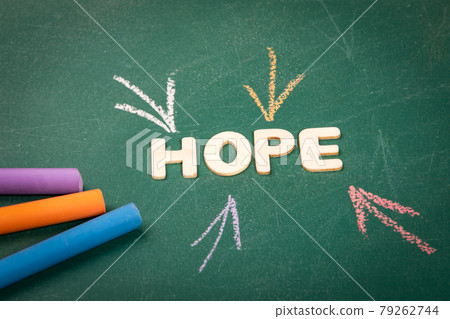 HOPE. Wooden alphabet letters on a green blackboard background HOPE. Wooden alphabet letters on a green blackboard background 79262744
