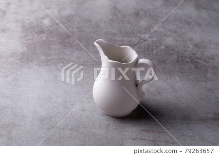 Teapot creamer, Cup and saucer on Cement Board Teapot creamer, Cup and saucer on Cement Board 79263657