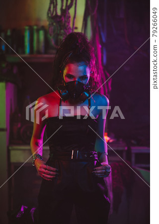 girl in cyberpunk style in a gas mask suit with a neon light at night girl in cyberpunk style in a gas mask suit with a neon light at night 79266049