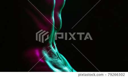 Sexy naked wet body of a girl with water drops. A skinny belly in the neon light Sexy naked wet body of a girl with water drops. A skinny belly in the neon light 79266302