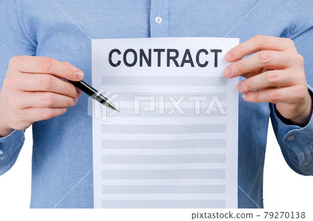 Concept offer to sign a contract. A man in a blue shirt is holding a sheet with a contract and a pen on a white background. Concept offer to sign a contract. A man in a blue shirt is holding a sheet with a contract and a pen on a white background. 79270138