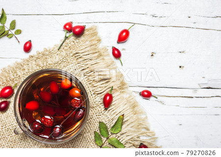 Rose hips tea on a rustic background 79270826