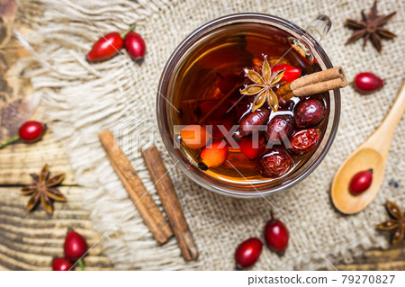 Rose hips tea on a rustic background 79270827