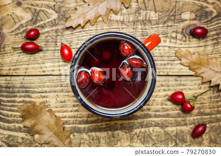 Rose hips tea on a rustic background Rose hips tea on a rustic background 79270830
