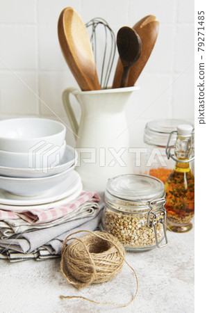 Kitchen utensils, tools and dishware on on the background white tile wall. 79271485