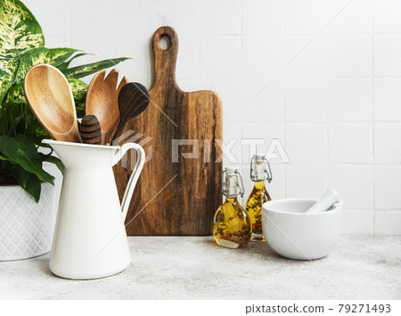 Kitchen utensils, tools and dishware on on the background white tile wall. 79271493