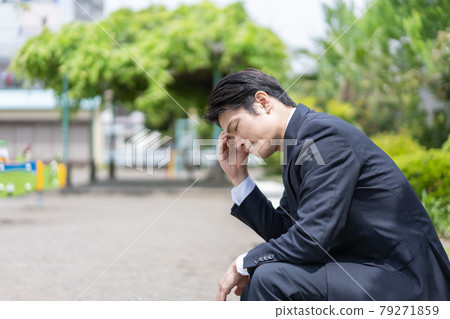 Businessman falling in the park 79271859