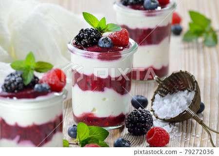 Light and cool summer dessert with curd, yoghurt und fresh berries 79272036