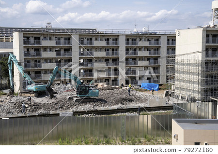 Old apartment building under demolition, shovel car 79272180
