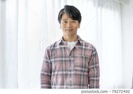 A smiling man in his 50s looking at the camera portrait 79272492
