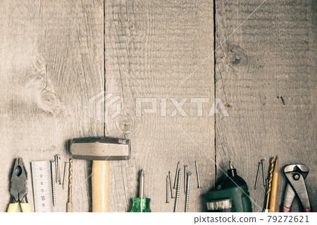 DIY tools placed side by side on a wooden board DIY tools placed side by side on a wooden board 79272621