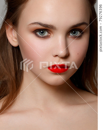 Makeup, cosmetics. Beauty young woman portrait. Beautiful model girl with beauty makeup , red lips , perfect fresh skin . Attractive lady with green eyes. Youth and Skin Care Concept Makeup, cosmetics. Beauty young woman portrait. Beautiful model girl with beauty makeup , red lips , perfect fresh skin . Attractive lady with green eyes. Youth and Skin Care Concept 79276396