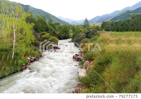 Beautiful landscape near the city of Almaty, Kazakhstan on a mountain stream in clear summer weather Beautiful landscape near the city of Almaty, Kazakhstan on a mountain stream in clear summer weather 79277173