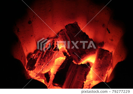 Red-hot charcoal fire in a Japanese charcoal grill against a black background. Red-hot charcoal fire in a Japanese charcoal grill against a black background. 79277229