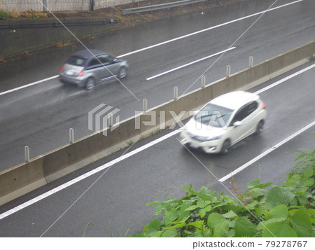 A car running on the Yokohama Bypass on a rainy day A car running on the Yokohama Bypass on a rainy day 79278767