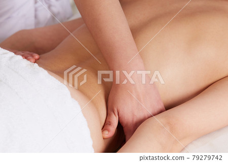 Female Enjoying Relaxing Massage In Cosmetology Spa Center 79279742