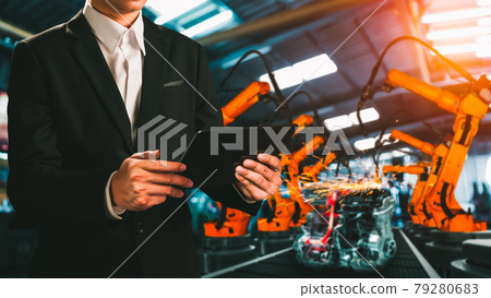 Engineer use advanced robotic software to control industry robot arm in factory 79280683