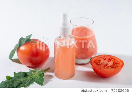 Tomatoes juice spray for skin care. 79282696