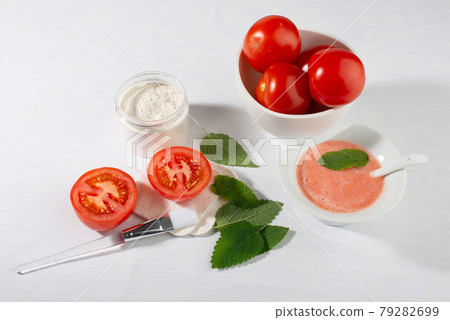 Tomatoes for skin care. Facial mask ingredients: tomatoes, white clay, mint leaves. 79282699