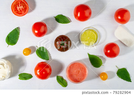 Tomatoes for skin care. Facial mask ingredients: tomatoes, lemon, mint leaves. Flat lay, top view. Tomatoes for skin care. Facial mask ingredients: tomatoes, lemon, mint leaves. Flat lay, top view. 79282904