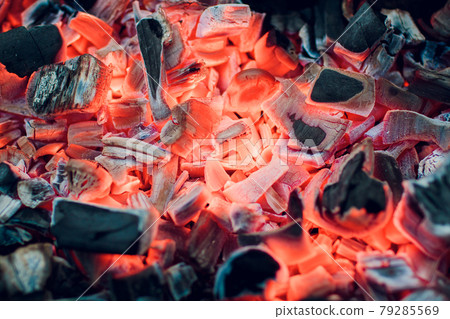 Burning coals. Decaying charcoal. Texture embers closeup. burning charcoal in the background. burning coals of a fire.Smoldering ashes. BBQ barbecue. Night light. Decaying charcoal, barbeque season. 79285569