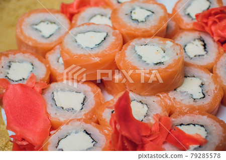 Beautifully decorated sushi on a plate and chopsticks are near it. Sushi is the traditional Asian and Japanese food. Roll of sushi prepared from raw fish and a special rice. Diet healthy food. Beautifully decorated sushi on a plate and chopsticks are near it. Sushi is the traditional Asian and Japanese food. Roll of sushi prepared from raw fish and a special rice. Diet healthy food. 79285578