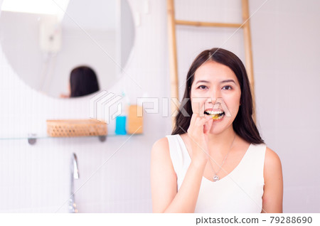 Asian woman putting braces teeth or silicone trainer,Orthodontic,Dental health concept,Decayed tooth 79288690