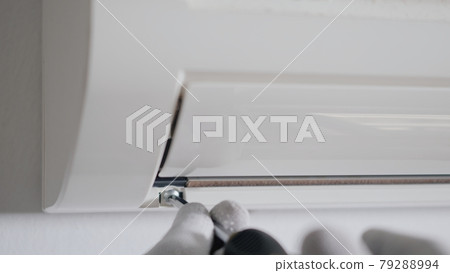 Technician service checking and repair air conditioner house indoors on the wall 79288994