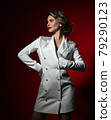 Self-confident wealthy blonde woman in long white 79290123