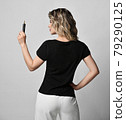 Blonde curly woman in black t-shirt and white 79290125
