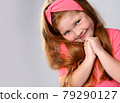 Portrait of cute, sly smiling redhead kid girl 79290127
