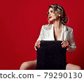 Young seductive sexy blonde woman in white jacket 79290130
