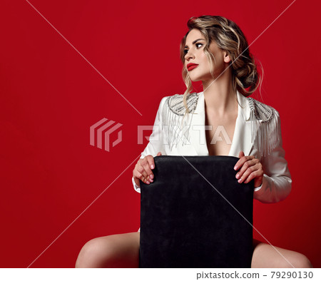 Young seductive sexy blonde woman in white jacket 79290130