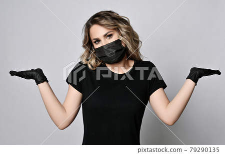 Blonde curly woman in black t-shirt, protective 79290135