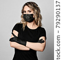 Portrait of blonde curly woman in black t-shirt 79290137