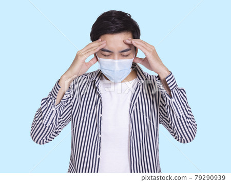 The handsome young man felt medical mask. The handsome young man felt medical mask. 79290939