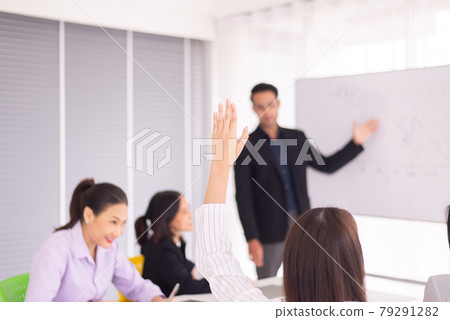 Audience woman raised hands and arms during meeting seminar,People sharing ideas and brainstorm,Asking and answer concept Audience woman raised hands and arms during meeting seminar,People sharing ideas and brainstorm,Asking and answer concept 79291282